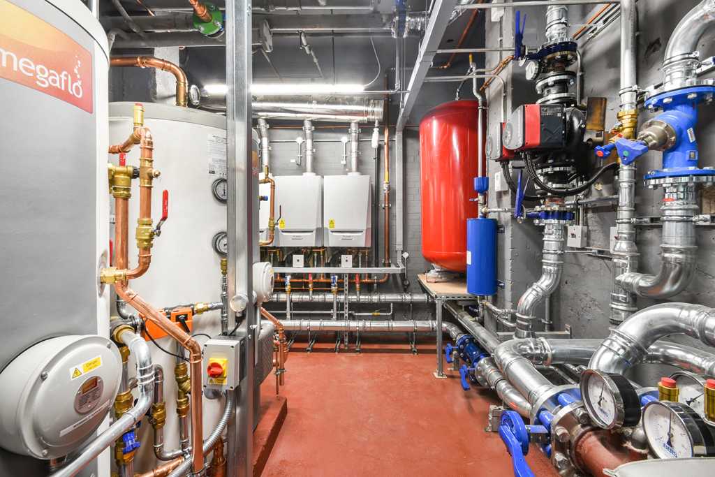 Plant engineer working on a commercial plant room installation
